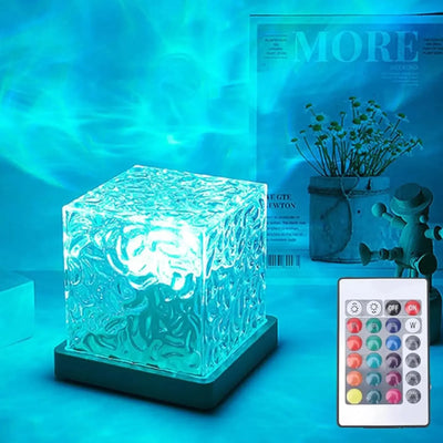 Ocean Wave Projector light cube with textured surface casting blue ocean wave patterns and remote control.